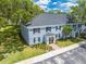 Aerial shot showcasing the building's charming blue brick, manicured lawn, and convenient parking area at 130 Lewfield Cir # 130, Winter Park, FL 32792