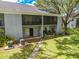 Exterior view showing private, screened-in patios/balconies and a well-maintained grassy area at 130 Lewfield Cir # 130, Winter Park, FL 32792