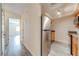 Galley kitchen features stainless steel refrigerator, wood cabinets, gray countertops, and vinyl flooring at 130 Lewfield Cir # 130, Winter Park, FL 32792