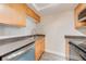 Bright kitchen featuring stainless steel appliances, gray countertops and wood cabinets at 130 Lewfield Cir # 130, Winter Park, FL 32792