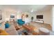 Living room is staged with modern furniture and decor, and features light wood-look vinyl floors at 130 Lewfield Cir # 130, Winter Park, FL 32792