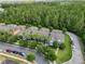 An aerial view of colorful townhouses, palm trees, and parked cars lining a beautiful community at 14743 Driftwater Dr, Winter Garden, FL 34787