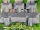 Birds-eye view of townhome roofs and brick-paved driveways surrounded by tropical palm trees and green spaces at 14743 Driftwater Dr, Winter Garden, FL 34787