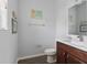 Cozy half bathroom with nautical decor, vanity, and a modern toilet at 14743 Driftwater Dr, Winter Garden, FL 34787