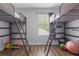 Spacious bedroom featuring bunk beds, ample natural light, and neutral wall color at 14743 Driftwater Dr, Winter Garden, FL 34787