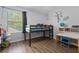 Bright bedroom featuring a loft bed, a large window, and desk at 14743 Driftwater Dr, Winter Garden, FL 34787