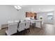 Open-concept dining room flows into a kitchen with island seating and stainless appliances at 14743 Driftwater Dr, Winter Garden, FL 34787