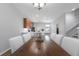 Open-concept dining area flows into a kitchen with island seating and stainless appliances at 14743 Driftwater Dr, Winter Garden, FL 34787