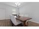 This dining room showcases a stylish wooden table with white seating and modern chandelier lighting at 14743 Driftwater Dr, Winter Garden, FL 34787