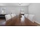 Bright dining room featuring a wooden table with white chairs and modern chandelier lighting at 14743 Driftwater Dr, Winter Garden, FL 34787