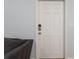 Interior white door with keyless entry and gray couch at 14743 Driftwater Dr, Winter Garden, FL 34787
