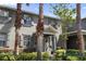 Inviting two-story home boasts a blue door, lush landscaping, and curb appeal at 14743 Driftwater Dr, Winter Garden, FL 34787