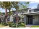 Street view of townhomes boasting a blue door, lush landscaping, and curb appeal at 14743 Driftwater Dr, Winter Garden, FL 34787