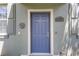 Home exterior featuring blue front door with keyless entry and home number at 14743 Driftwater Dr, Winter Garden, FL 34787