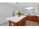 This kitchen features wood cabinets, white countertops, and an island with seating at 14743 Driftwater Dr, Winter Garden, FL 34787