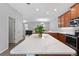 Spacious kitchen with wood cabinets, white countertops, and an island with seating at 14743 Driftwater Dr, Winter Garden, FL 34787