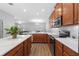 Well-lit kitchen featuring wood cabinetry, stainless appliances, and white countertops at 14743 Driftwater Dr, Winter Garden, FL 34787