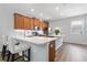 The kitchen features wood cabinets, stainless appliances, white countertops, and island seating at 14743 Driftwater Dr, Winter Garden, FL 34787