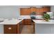 Well-lit kitchen featuring wood cabinetry, stainless appliances, and white countertops at 14743 Driftwater Dr, Winter Garden, FL 34787