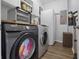 Functional laundry room with modern washer and dryer units, white cabinets, and efficient storage solutions at 14743 Driftwater Dr, Winter Garden, FL 34787