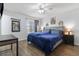 Stylish main bedroom with plush blue bedding, modern decor, and ample natural light at 14743 Driftwater Dr, Winter Garden, FL 34787