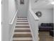 Elegant staircase featuring wood treads, white risers, and a modern handrail at 14743 Driftwater Dr, Winter Garden, FL 34787