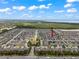 Expansive aerial view of a residential community with lush landscaping, showcasing the neighborhood's layout and serene environment at 1706 Leatherback Ln, St Cloud, FL 34771