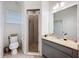 Bathroom with granite vanity top, glass-enclosed shower, and tile flooring at 1706 Leatherback Ln, St Cloud, FL 34771