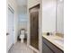 Bathroom featuring a glass-enclosed shower, vanity, and toilet at 1706 Leatherback Ln, St Cloud, FL 34771