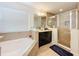 Bright bathroom featuring a soaking tub, glass shower, and double vanity sink at 1706 Leatherback Ln, St Cloud, FL 34771