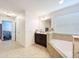 Bright bathroom with soaking tub and access to main bedroom area at 1706 Leatherback Ln, St Cloud, FL 34771