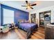 Bedroom with blue accent wall, closet, and wood flooring at 1706 Leatherback Ln, St Cloud, FL 34771