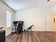 Bedroom with wood-look flooring, featuring a ceiling fan and lots of natural light from the windows at 1706 Leatherback Ln, St Cloud, FL 34771