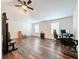 Spacious bedroom featuring wood-look flooring, a ceiling fan, and lots of natural light at 1706 Leatherback Ln, St Cloud, FL 34771