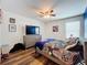This bedroom features wood-look flooring, a ceiling fan, and a large window at 1706 Leatherback Ln, St Cloud, FL 34771