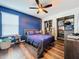 Bedroom with blue accent wall, closet, and wood flooring at 1706 Leatherback Ln, St Cloud, FL 34771