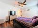 Bedroom with wood floors, a dresser, and a ceiling fan at 1706 Leatherback Ln, St Cloud, FL 34771