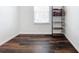 This bonus room features wood-look flooring, a window, and shelving at 1706 Leatherback Ln, St Cloud, FL 34771