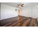 This bonus room features wood-look flooring, neutral walls, and an inviting ceiling fan at 1706 Leatherback Ln, St Cloud, FL 34771