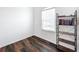 This bonus room features wood-look flooring, a window, and shelving at 1706 Leatherback Ln, St Cloud, FL 34771