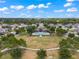 Aerial shot of community pool and recreation area, featuring a clubhouse, playground, and lush green spaces at 1706 Leatherback Ln, St Cloud, FL 34771
