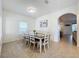 Open dining space with tiled floors, neutral paint, and decorative molding on the walls in a brightly lit space at 1706 Leatherback Ln, St Cloud, FL 34771