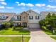 Charming two-story home with a stone facade, well-manicured lawn, and a brick driveway for a sophisticated look at 1706 Leatherback Ln, St Cloud, FL 34771