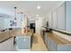 Modern kitchen boasts granite countertops, stainless steel appliances, and island seating under pendant lights at 1706 Leatherback Ln, St Cloud, FL 34771