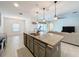 The kitchen features stainless steel appliances, a granite countertop island, and seamless access to the living area at 1706 Leatherback Ln, St Cloud, FL 34771