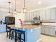 Bright kitchen with stainless steel appliances, granite countertops, and pendant lighting over the island at 1706 Leatherback Ln, St Cloud, FL 34771