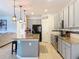 Well-lit kitchen features stainless steel appliances, granite countertops, and an island with pendant lighting at 1706 Leatherback Ln, St Cloud, FL 34771