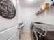 Well-organized laundry room with modern, front-load washer and dryer at 1706 Leatherback Ln, St Cloud, FL 34771