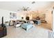 Expansive living area with a view of the kitchen, featuring a large sectional and modern decor at 1706 Leatherback Ln, St Cloud, FL 34771