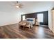 Bright and airy main bedroom featuring dark accent wall, ceiling fan, and hardwood floors at 1706 Leatherback Ln, St Cloud, FL 34771